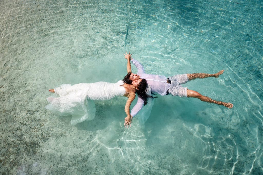 Trash the wedding dress floating in the lagoon of Bora Bora