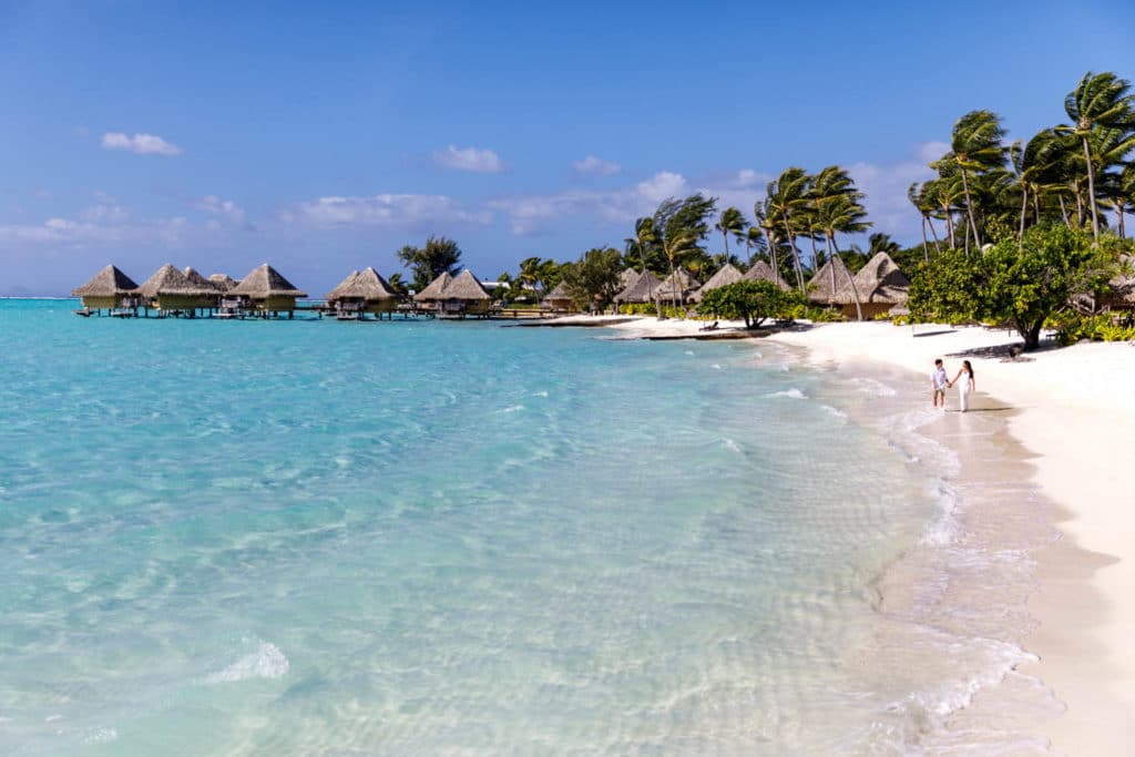 Livia & Marc walk on the beach of Bora Bora