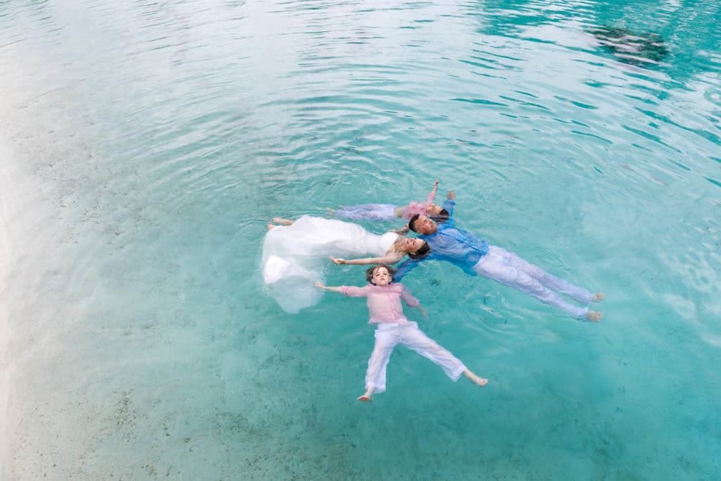 family floating in the lagoon