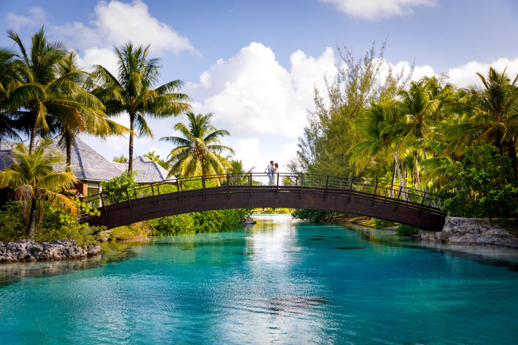 couple on top of the bridge by the spa of St Regis resort bora bora