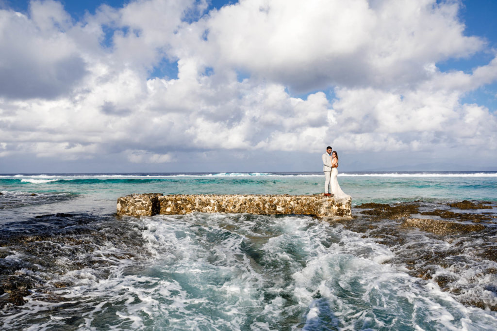 couple on top of the bridge of the ocean side at the St Regis Resort Bora Bora