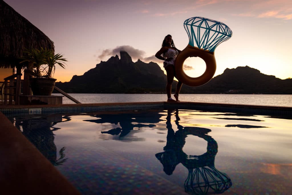 bride with ring floaty at sunset with otemanu view