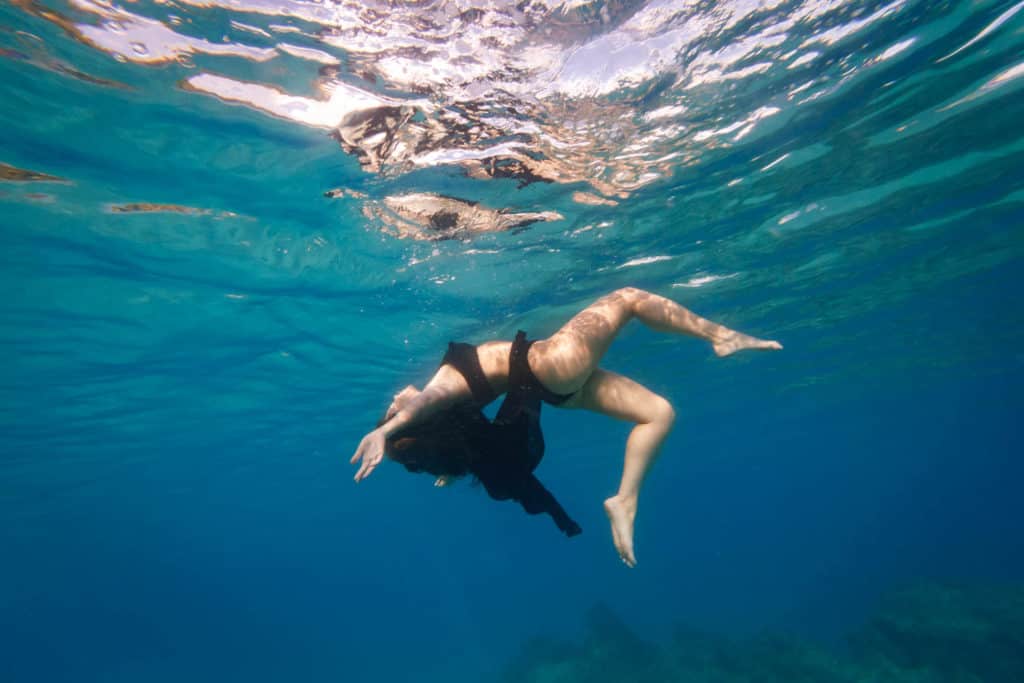 underwater women floating in the lagoon of bora bora