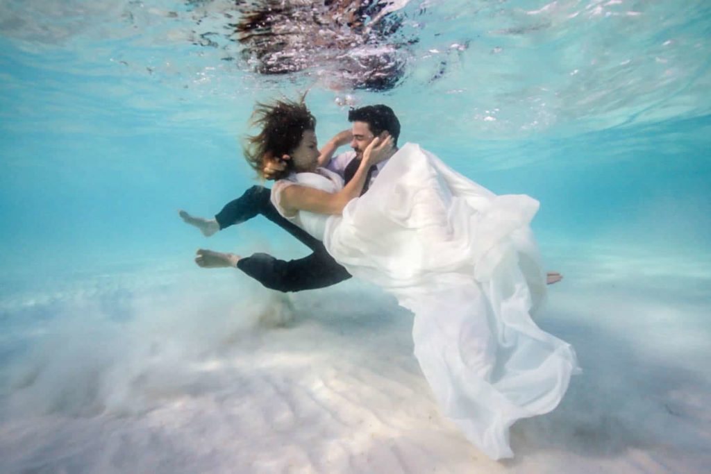Couple kissing under water
